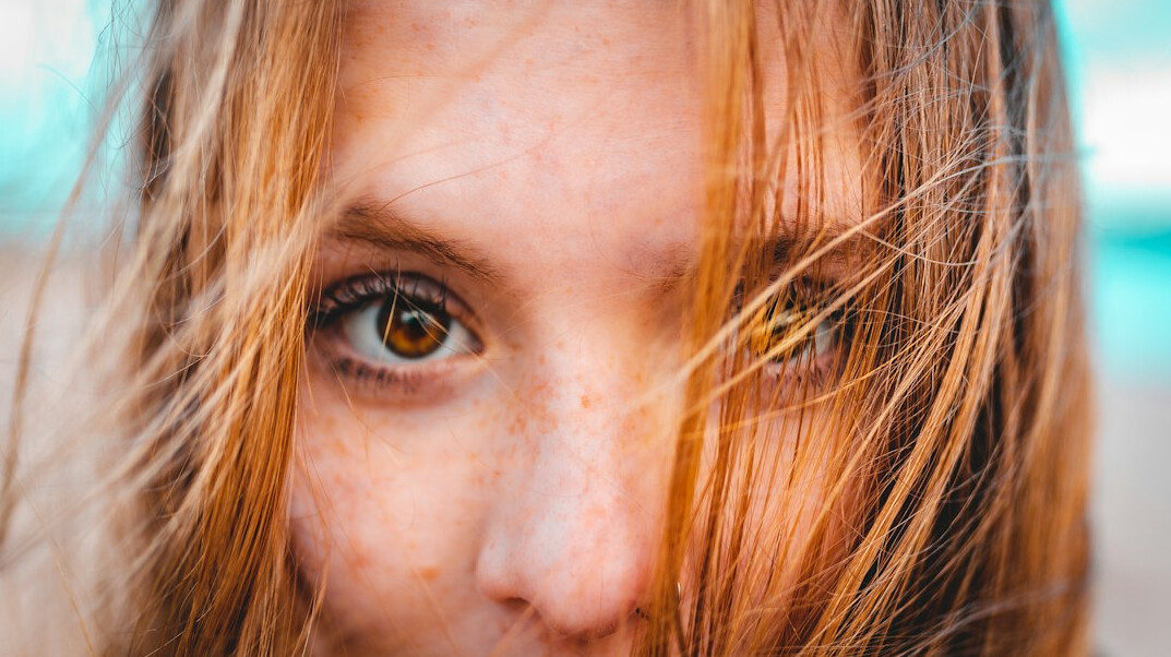 Portrait of a woman with light brown hair looking at the camera