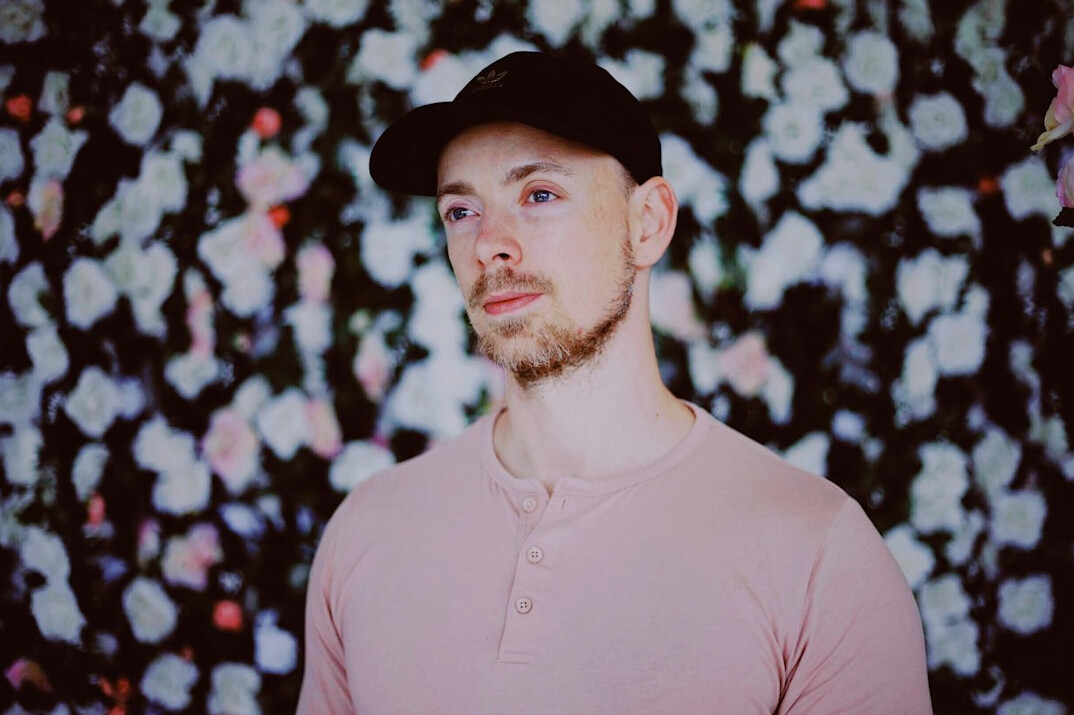 Portrait of a man with short hair and a light beard in a casual shirt